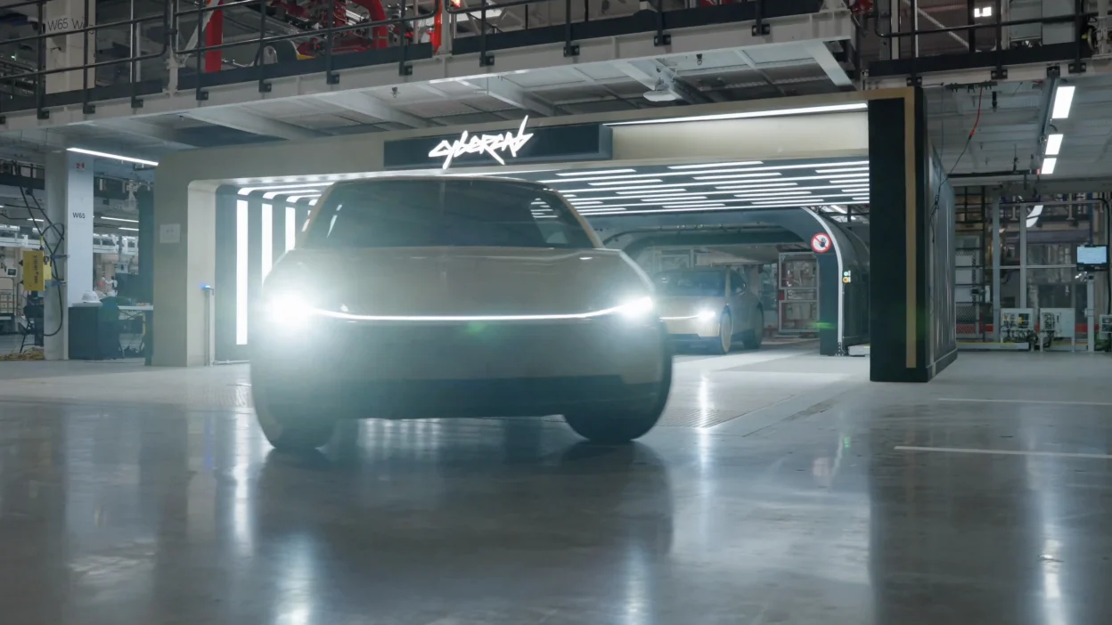 A Cybercab rolls out of the Tesla garage.