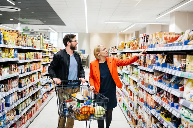 Mature Couple Selecting Groceries From Supermarket Shelf
