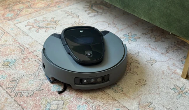 3i G10+ robot vacuum cleaning rug under green couch