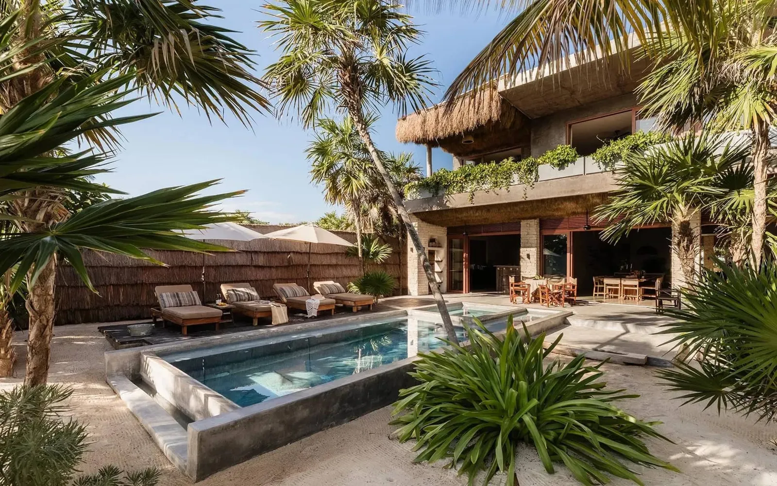 Image may contain Architecture Building House Housing Villa Chair Furniture Pool Water Swimming Pool and Summer