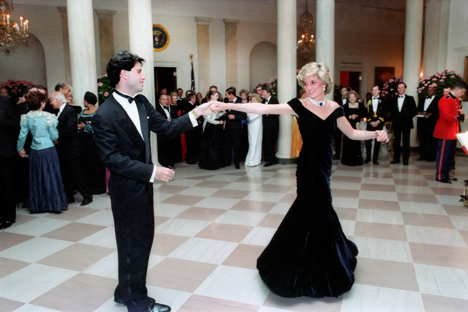 American actor John Travolta dancing with Princess Diana in Cross Hall of the White House