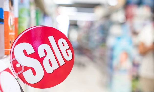 Sale sign on shelves in supermarket for promotion and special price offer to customer, Sale discount text display on the red poster.