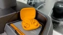 orange powerbeats pro sitting on workout equipment