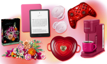 LEGO flower bouquet and box, burgundy Keurig, Kindle Paperwhite with pink case, red heart-shaped Le Creuset cast iron dish, pink Bose wireless earbuds, and red wireless Xbox controller arranged on pink, orange, yellow, and white backdrop