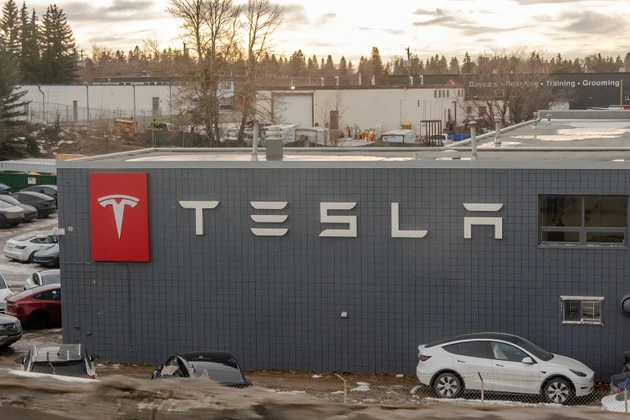 A Tesla vehicles are parked outside the service center, suggesting ongoing maintenance and customer support.