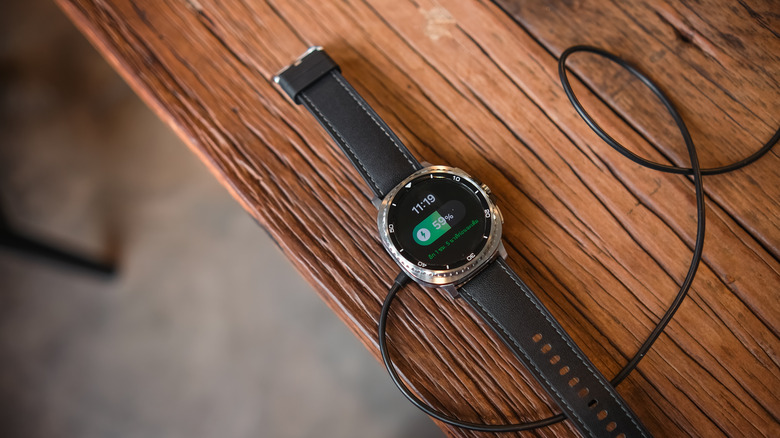 galaxy watch on a charger with battery status showing