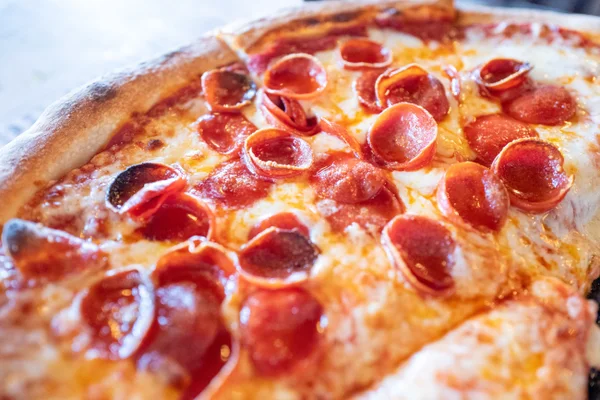 Half of a cheesy pepperoni pizza