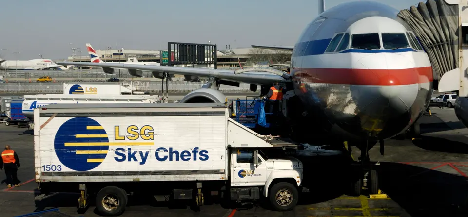An American Airlines jet is parked at a gate while passengers and cargo are handled. Air cargo move either in the "belly" of passenger jets or on freighters — dedicated cargo planes