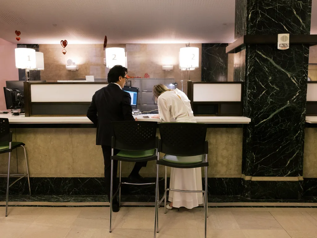 Image may contain Furniture Table Desk Adult Person Chair Indoors Lamp Computer Hardware Electronics and Hardware