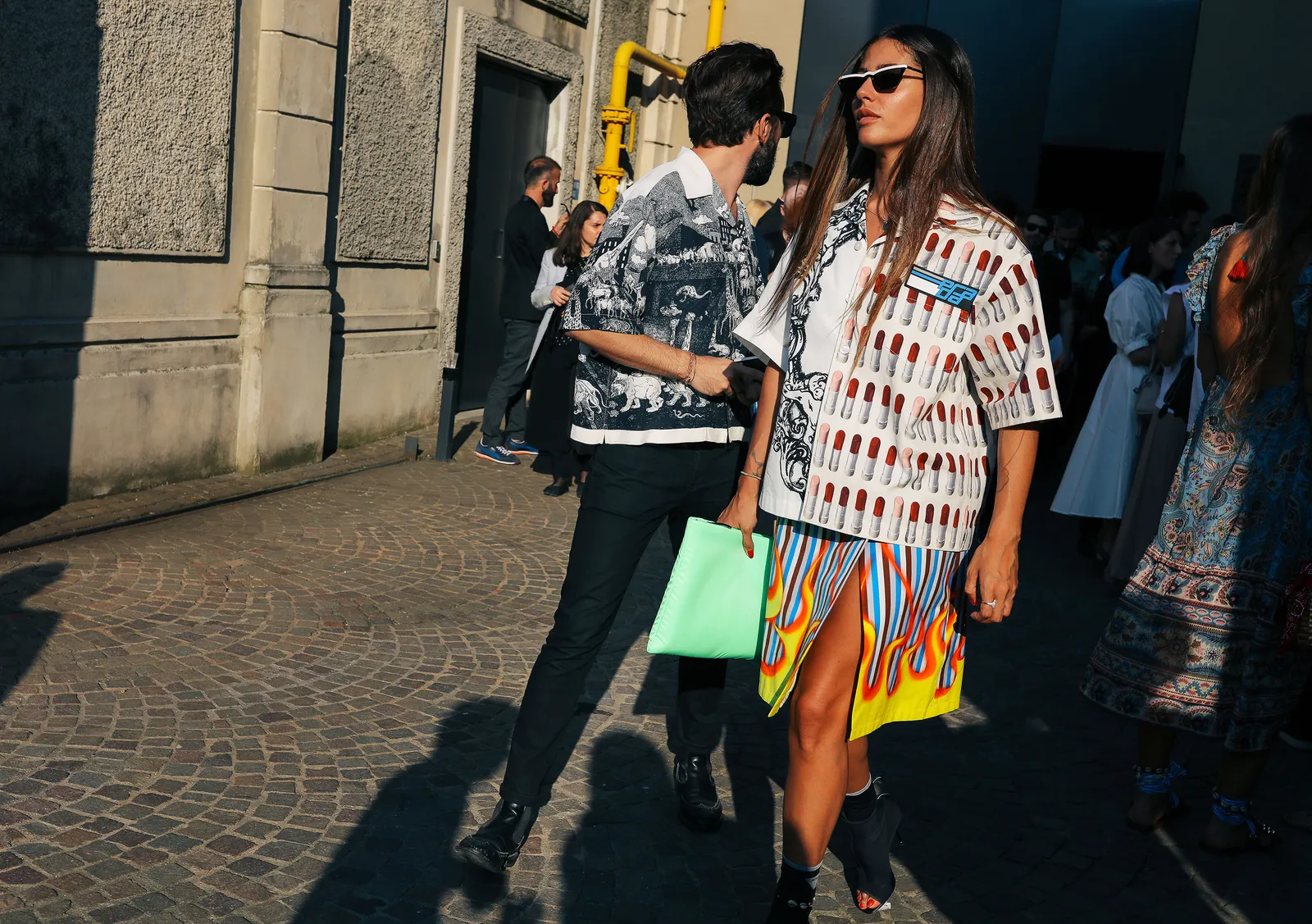 Image may contain Human Person Clothing Apparel Path Walkway Sunglasses Accessories Accessory and Sidewalk
