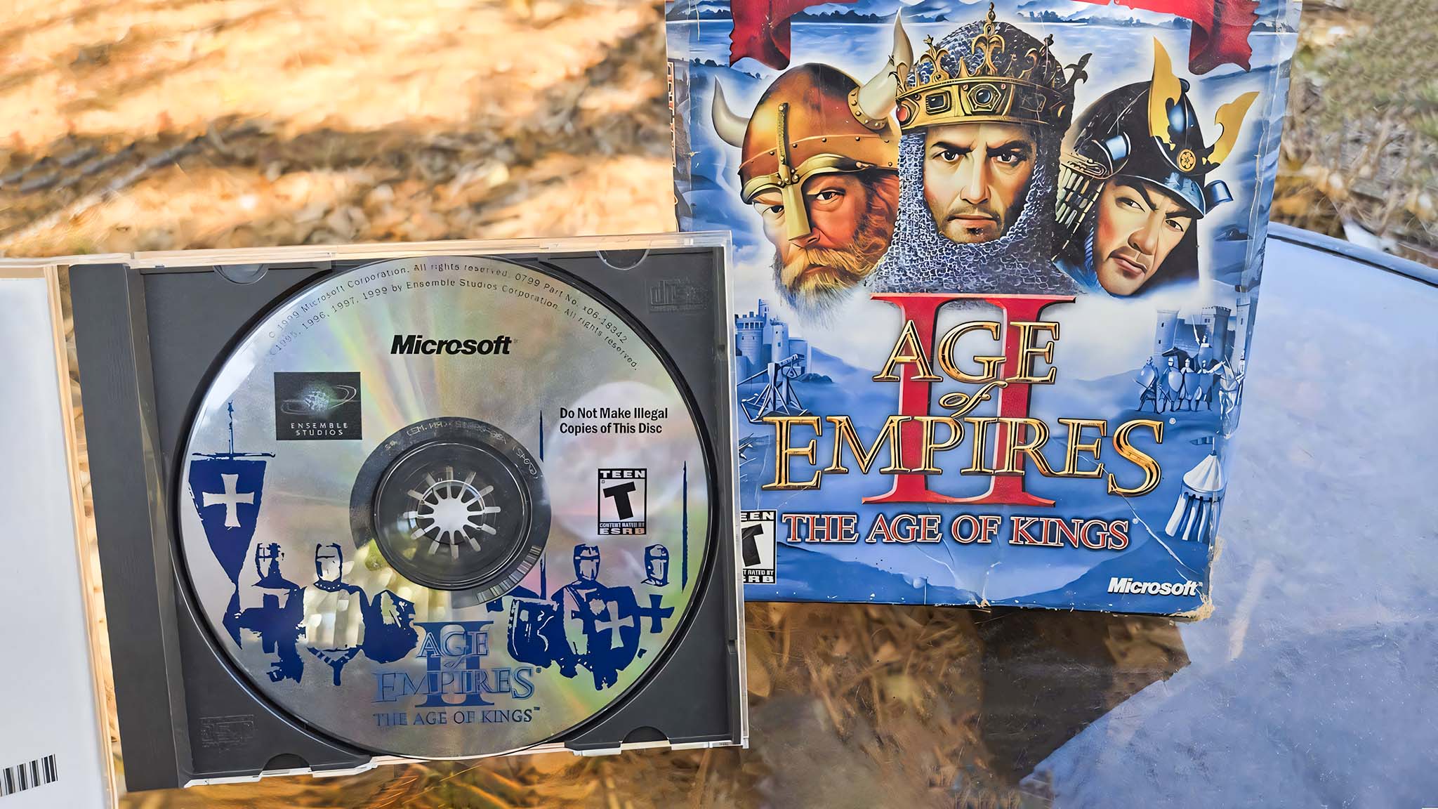Age of Empires II: Age of Kings original 90s disk in front of the original Game of the Year game box.