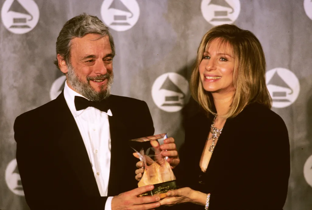Image may contain Stephen Sondheim Human Person Suit Coat Clothing Overcoat Apparel Barbra Streisand and Tie