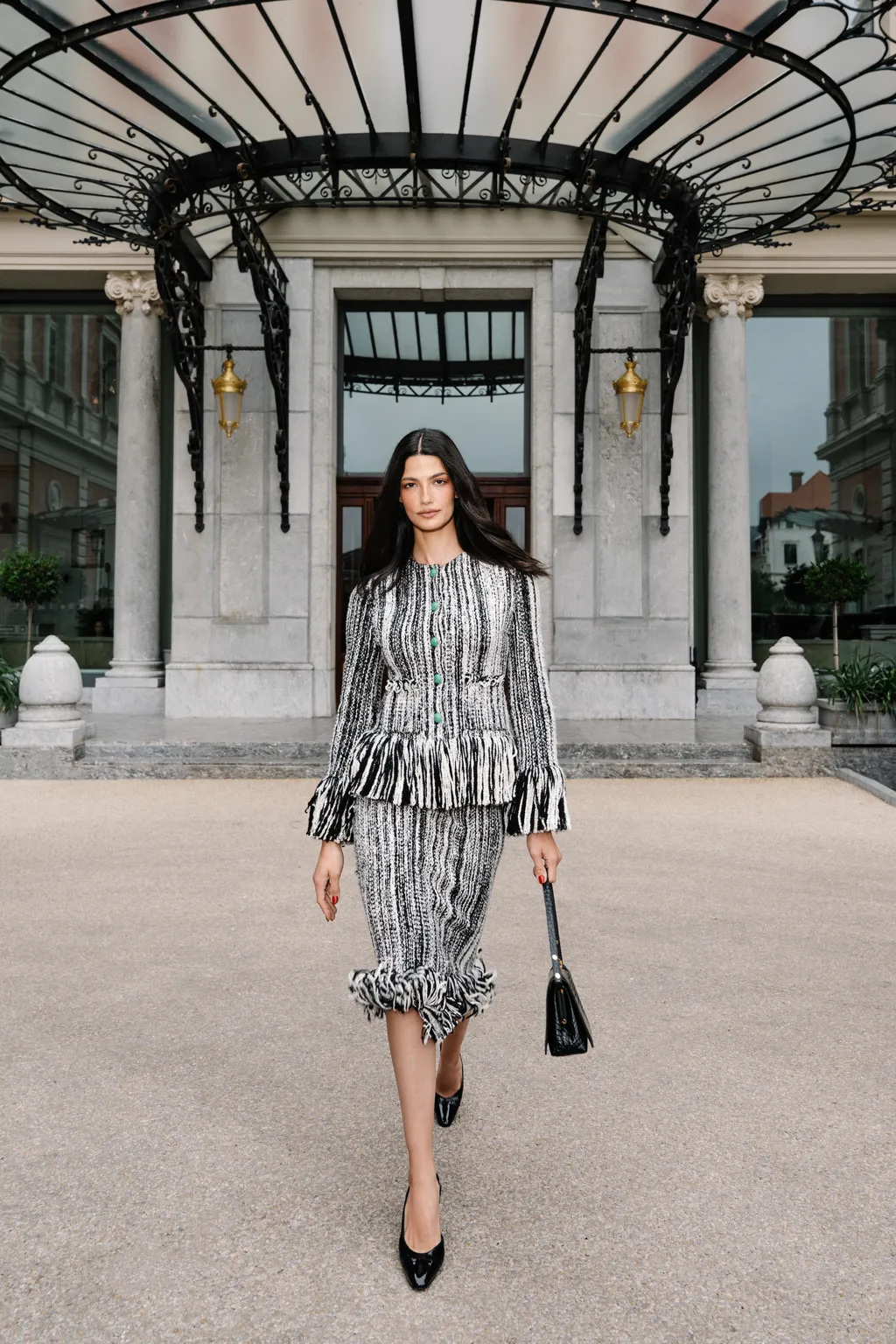 Image may contain Tara Emad Clothing Sleeve Adult Person Architecture Building House Housing Porch and Skirt