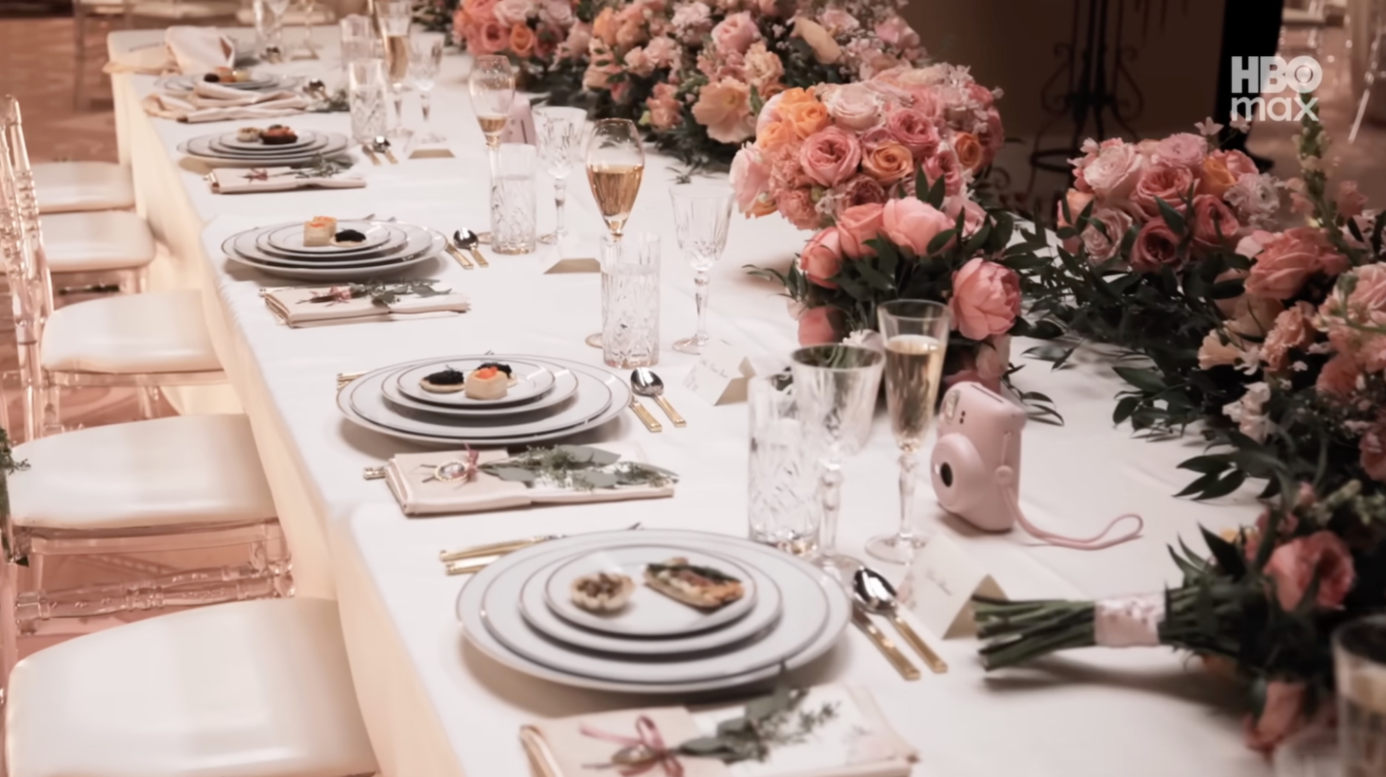 A table setting of pinks and roses.