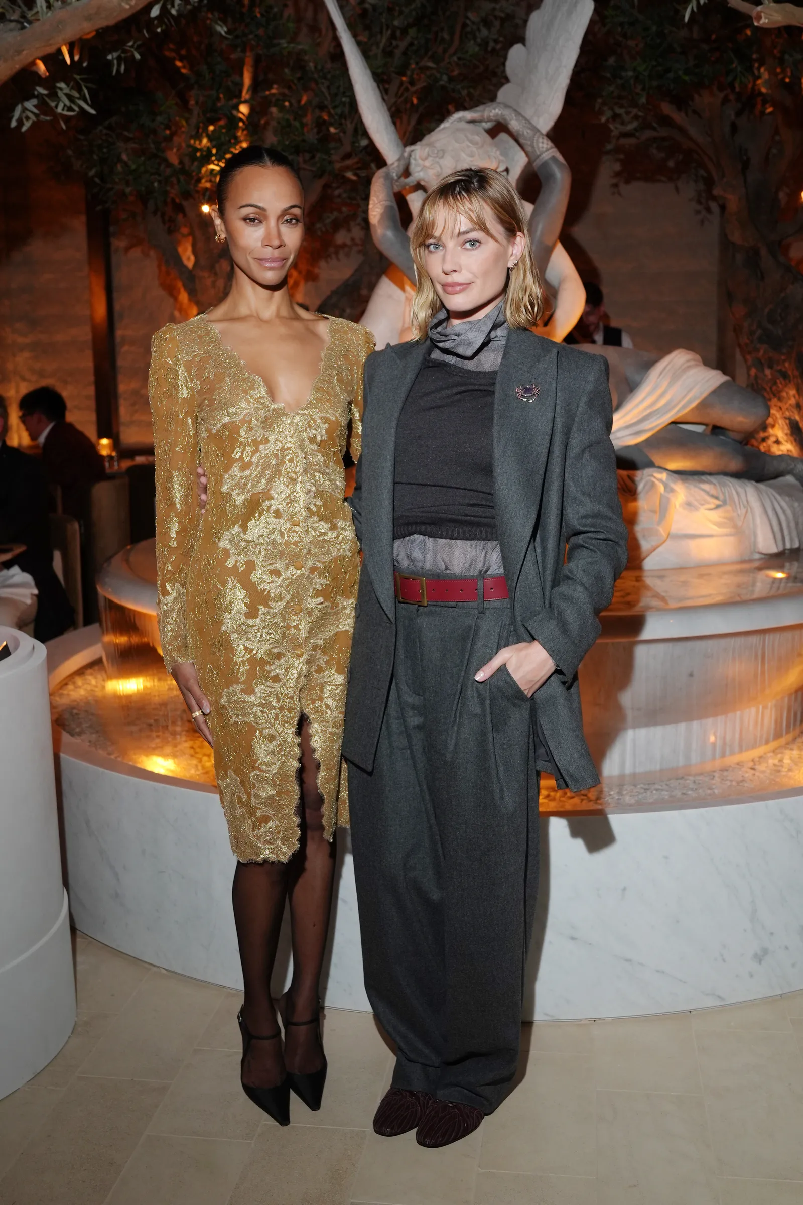 MILAN ITALY APRIL 21 Zoe Saldana and Margot Robbie attend the unveiling of RH Milan The Gallery on Corso Venezia event...