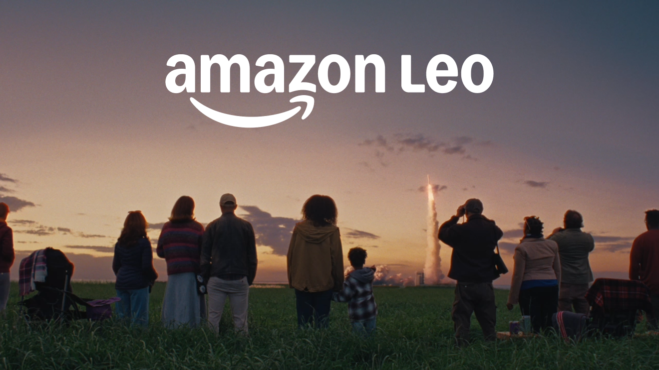 Group watching rocket launch at sunset, Amazon Leo logo above