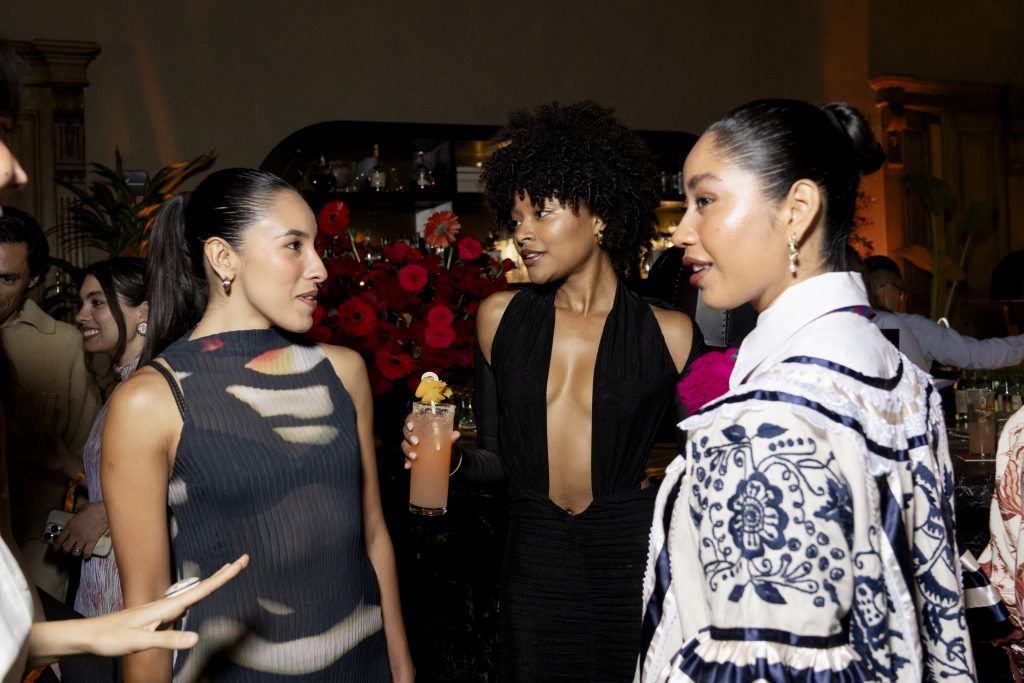 three people having a conversation at a party