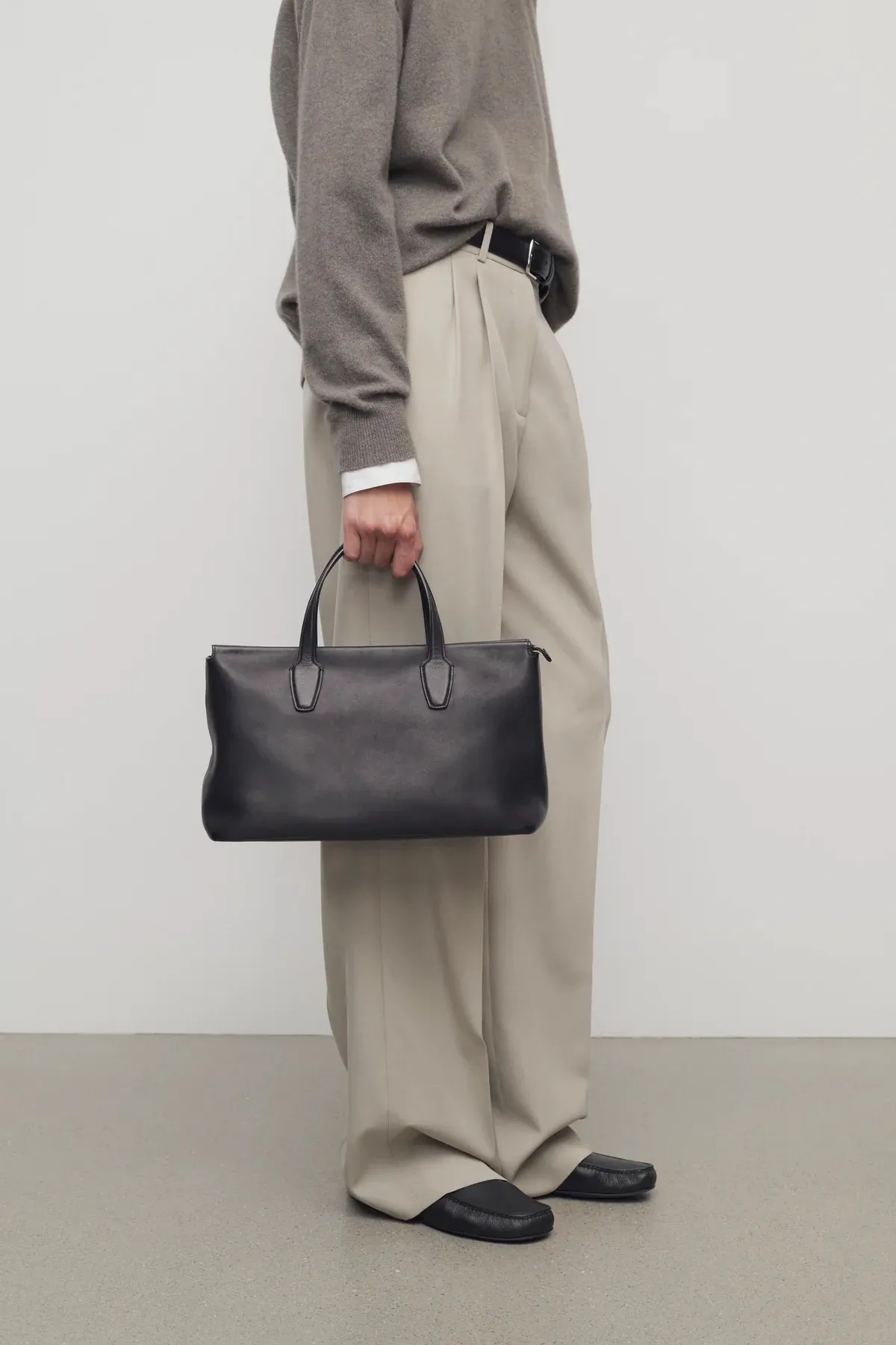 Image may contain Bag Accessories Handbag Clothing Pants and Coat