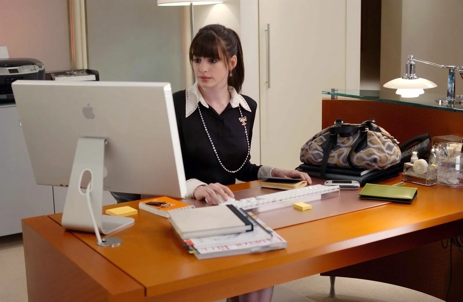 Image may contain Anne Hathaway Furniture Table Book Publication Desk Executive Person Accessories and Jewelry
