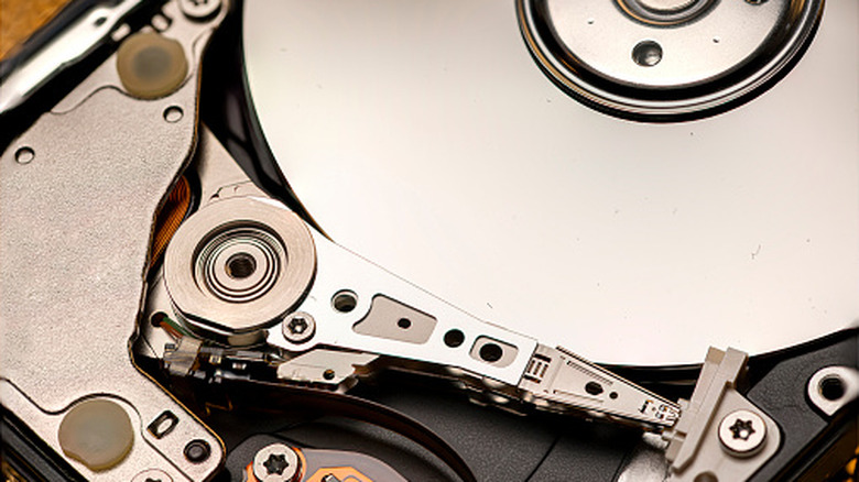 Internal components of a hard drive including the read/write head and magnetic platter