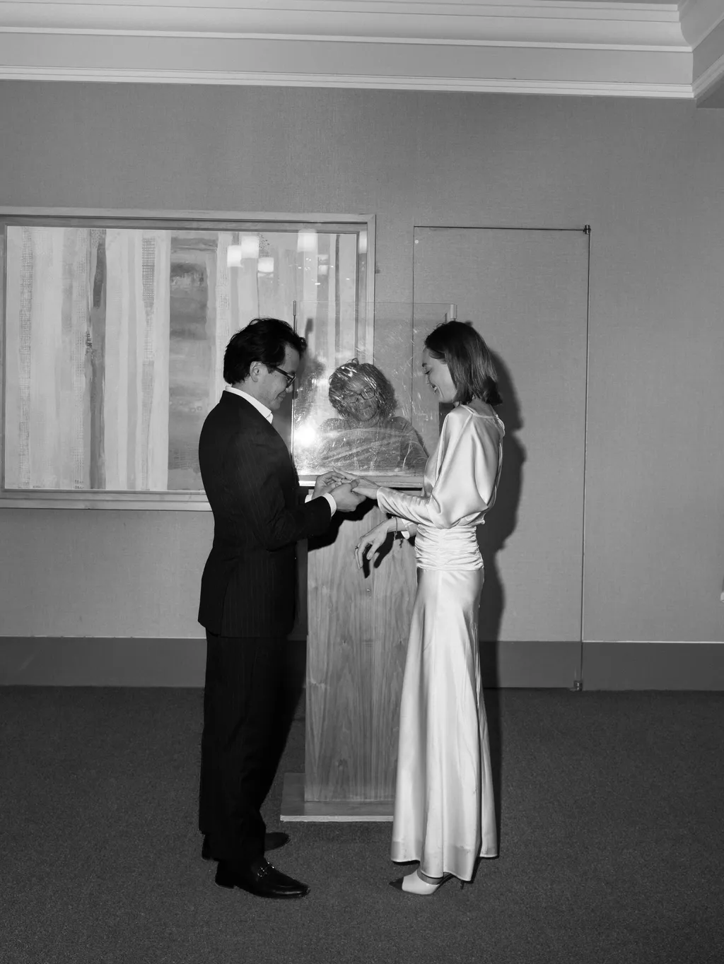 Image may contain Clothing Formal Wear Suit Dress Face Head Person Photography Portrait Fashion Gown and Tuxedo
