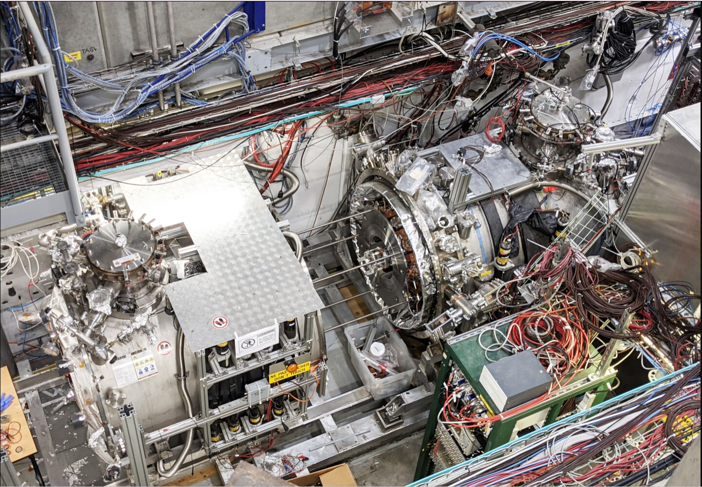 A view looking down into a large warehouse where various pieces of equipment are spread about.