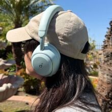 person sitting outside wearing soundcore space 2 headphones