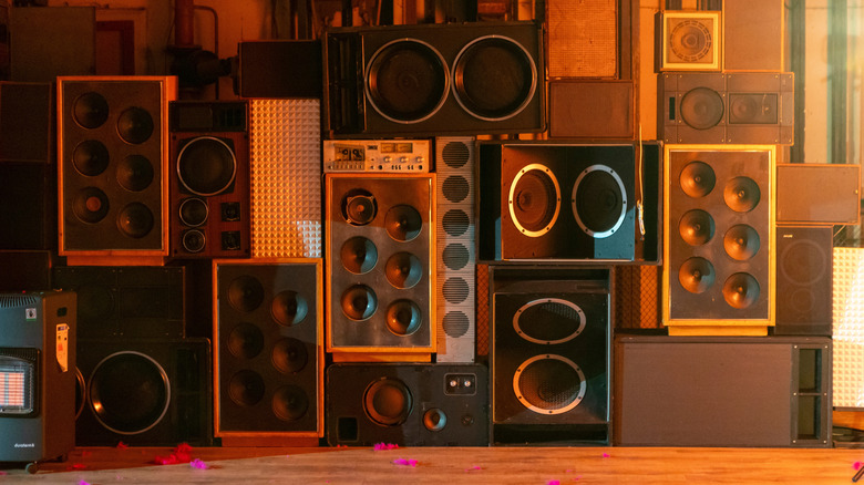 Multiple speakers and other audio equipment stacked