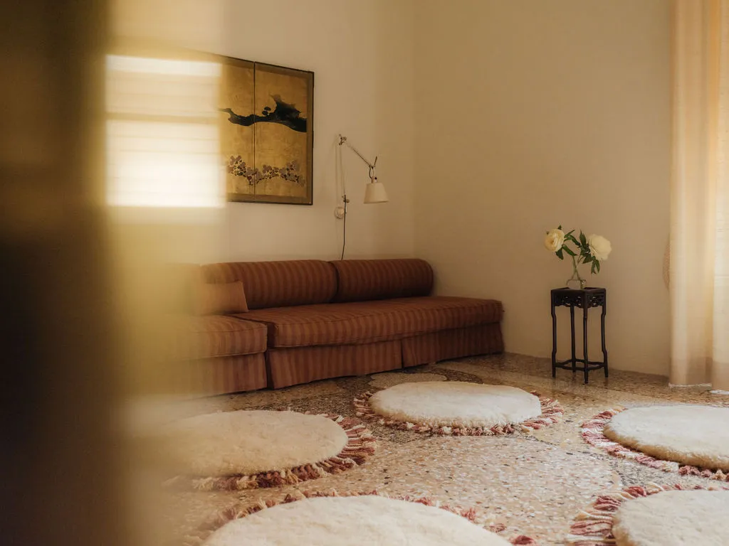 Image may contain Home Decor Rug Couch Furniture Corner Architecture Building Indoors Living Room Room and Lamp