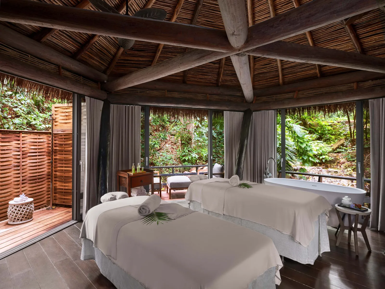 Image may contain Architecture Building Hotel Resort Bed Furniture Spa Chair Bathing Bathtub Person Tub and Sink