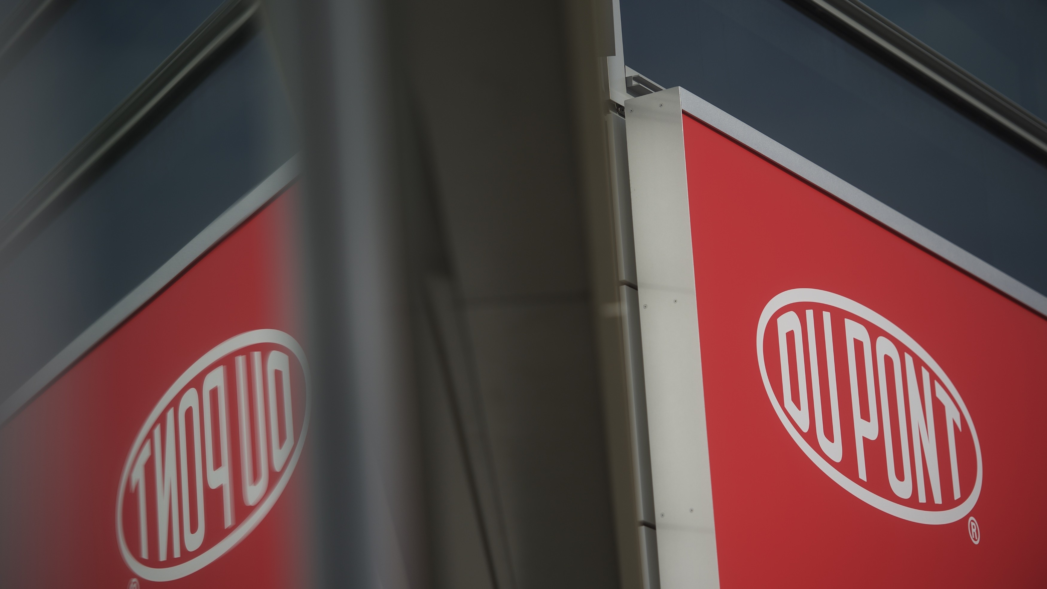 The DuPont logo reflected in a window.