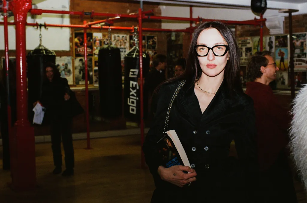 Image may contain Accessories Glasses Clothing Coat Adult Person Jacket Face Head Photography Portrait and Bag