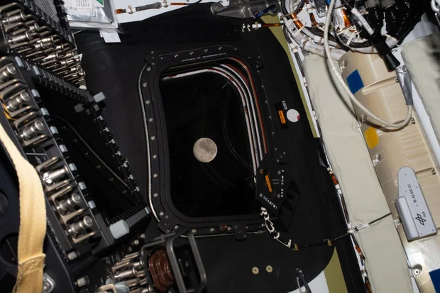 The moon is seen through the window of the Artemis II Orion spacecraft 