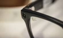 A close-up image of a small camera in the corner of the Ray-Ban Meta glasses frame.