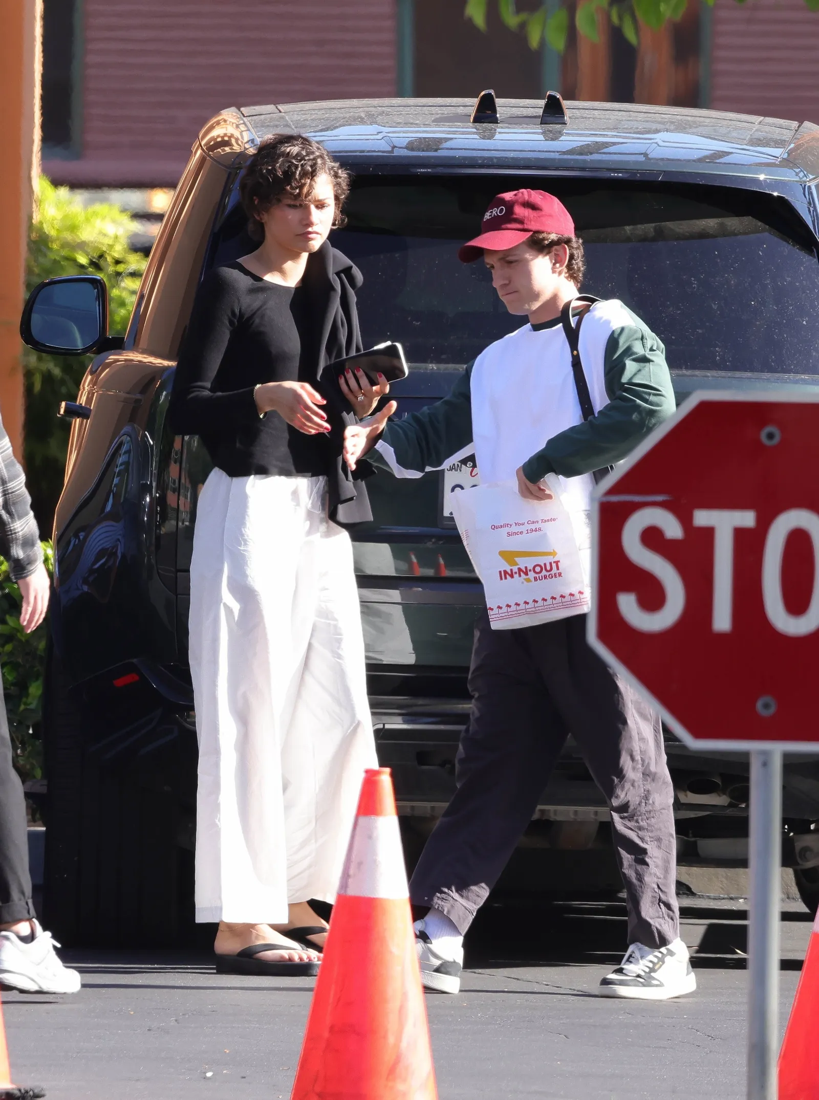 Image may contain Zendaya Tom Holland Advertisement Poster Adult Person Car Transportation Vehicle and Road Sign