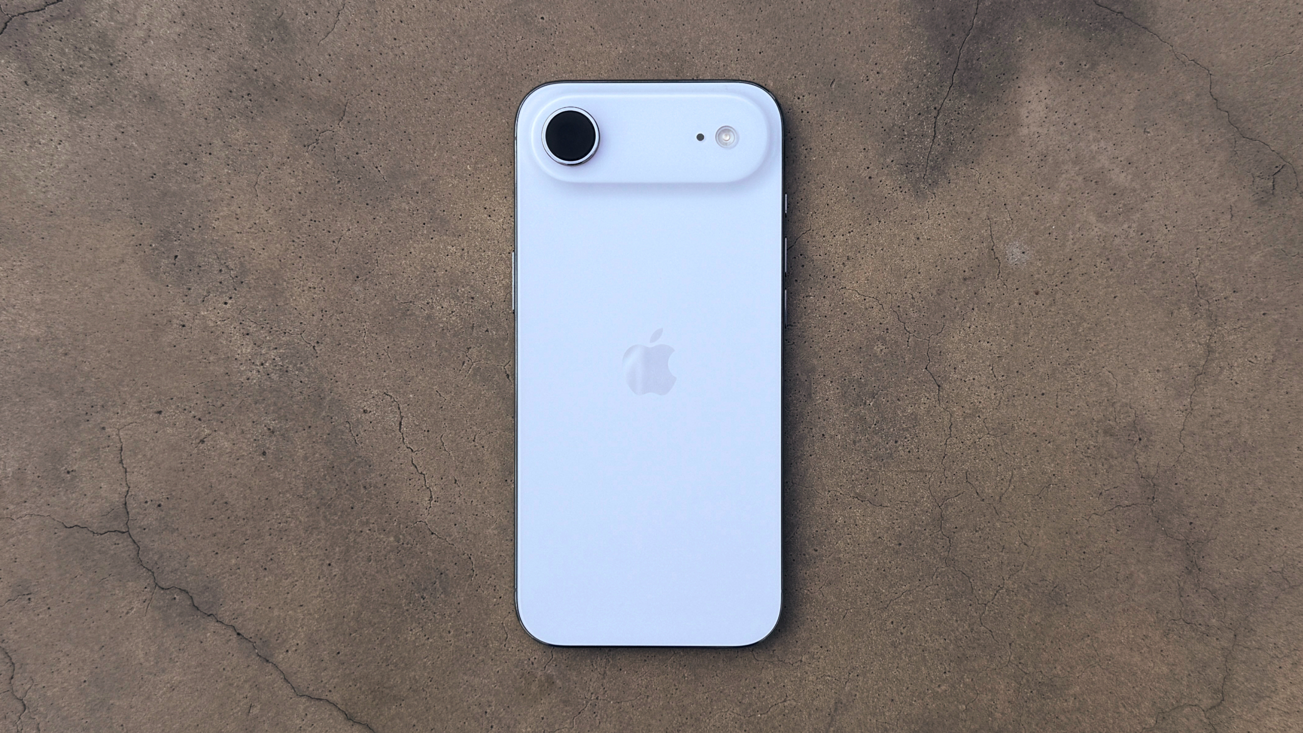 The iPhone Air lying on a stone surface