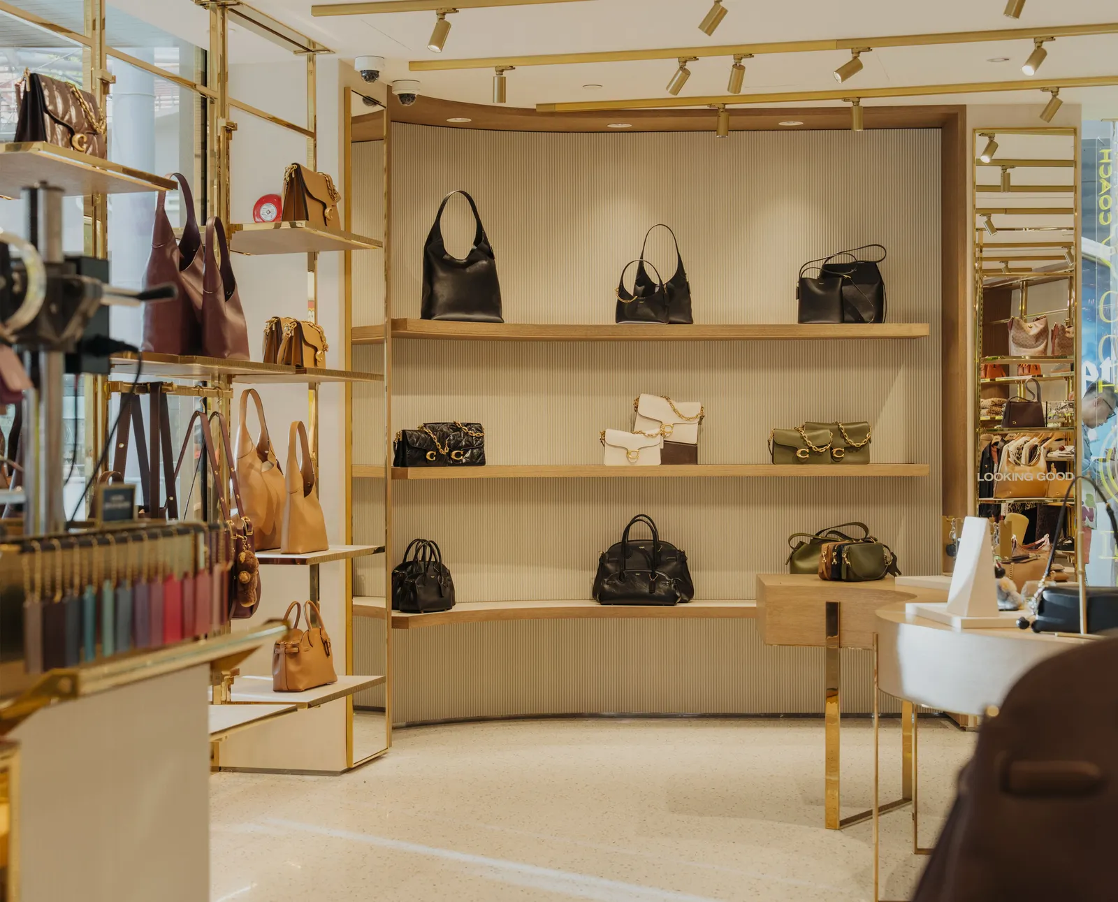 Image may contain Accessories Bag Handbag Purse Indoors Furniture Lamp Jewelry Necklace and Person
