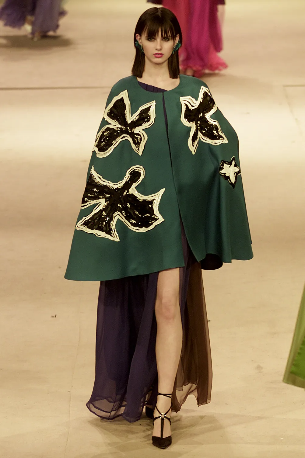 Image may contain Clothing Apparel Human Person Cape Fashion and Cloak