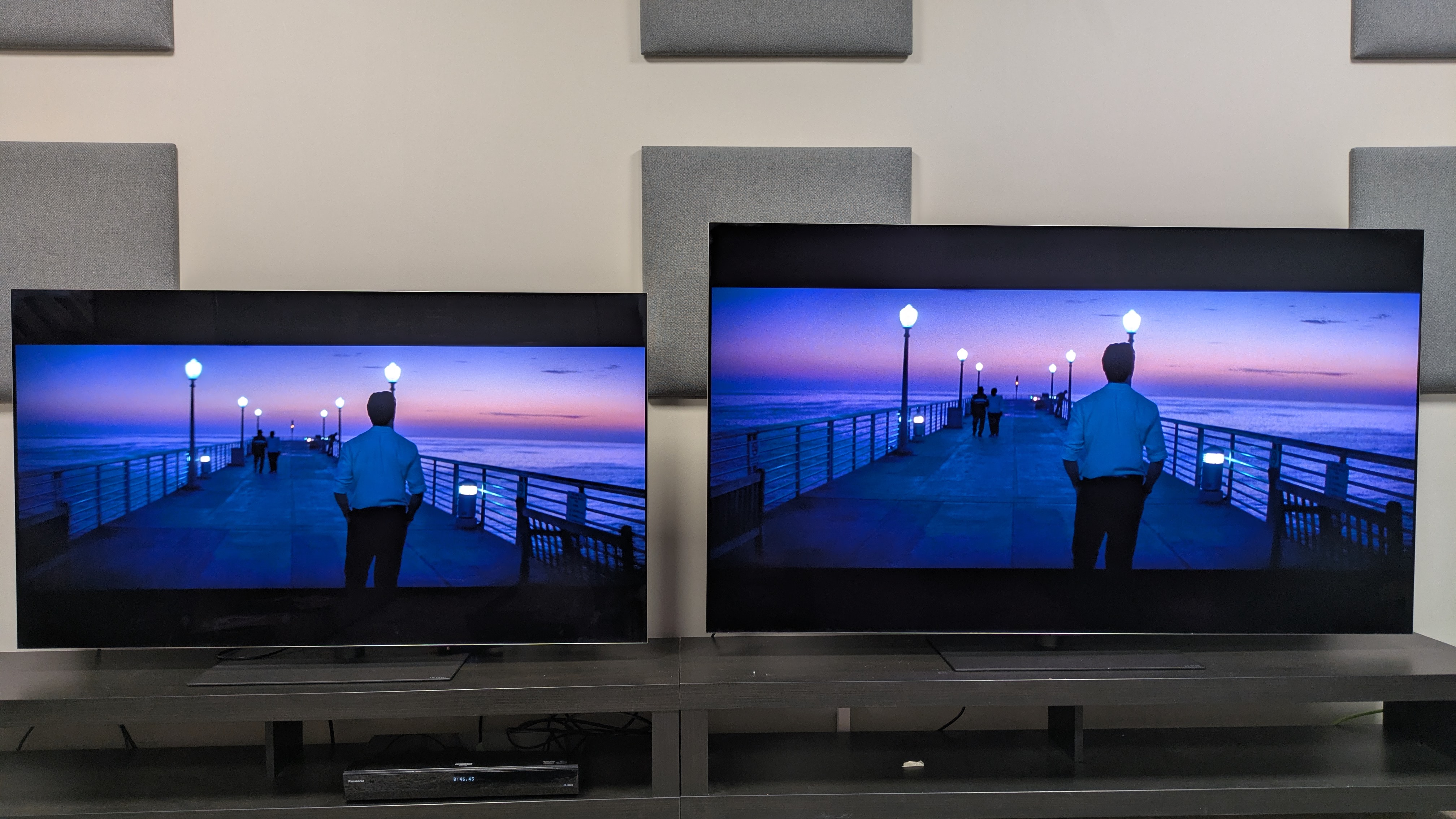 The LG G5 (left) and LG G6 (right) OLED TVs showing a scene from La La Land where Sebastian walks on a pier at sunset. The G5 shows signs of color banding in the sky, while the G6 appears more natural