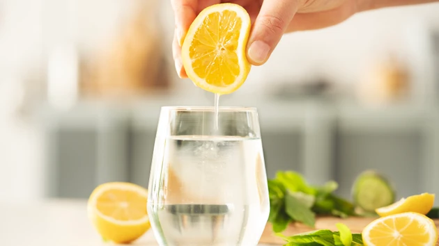 Squeezing lemon into drinking water