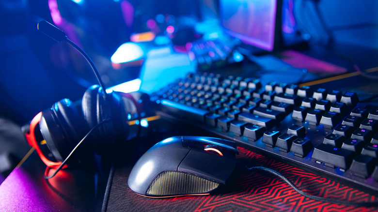 A mechanical keyboard alongside gaming equipment