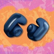 bose ultra open-ear earbuds against a pink and orange patterned background