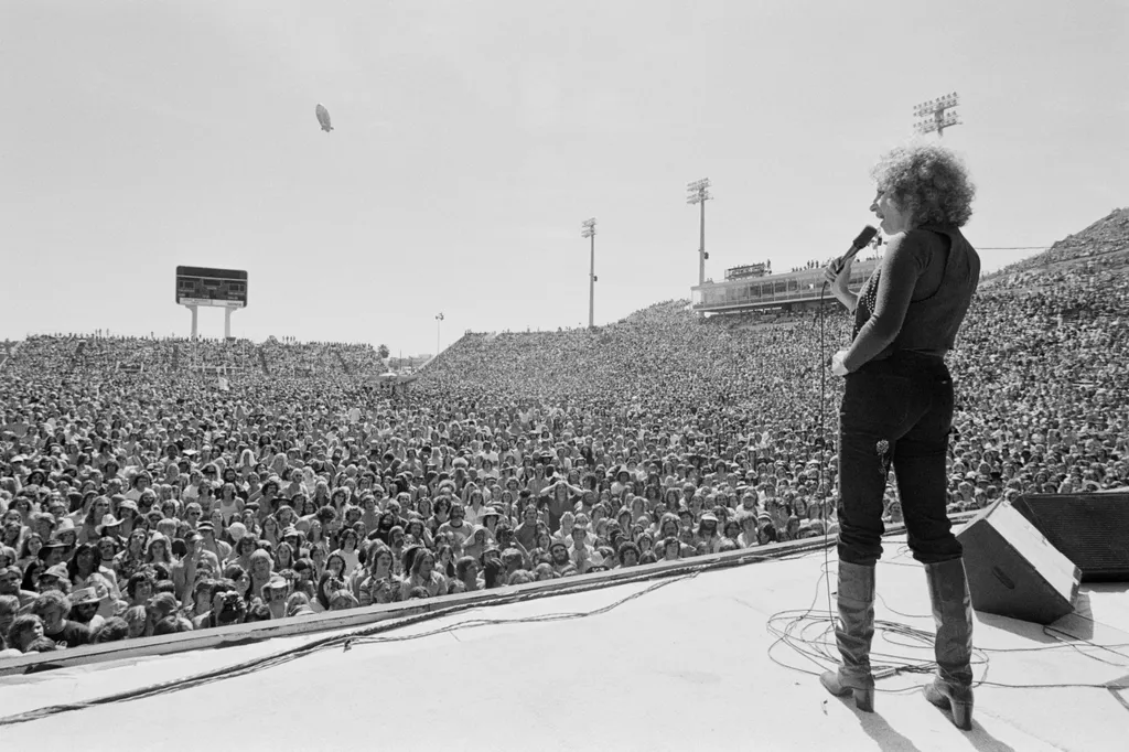 Image may contain Human Person Clothing Apparel Crowd Audience Animal and Bird