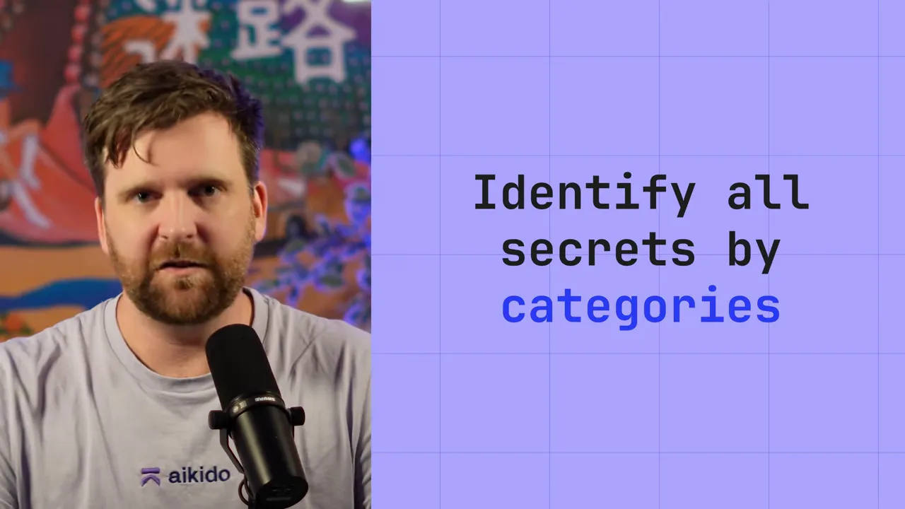 Presenter at a microphone with a slide reading 'Identify all secrets by categories'