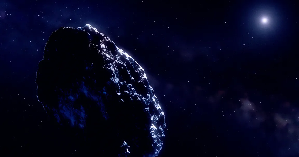 A large, rocky object illuminated by a distant light source, floating in the dark expanse of space filled with numerous small stars.