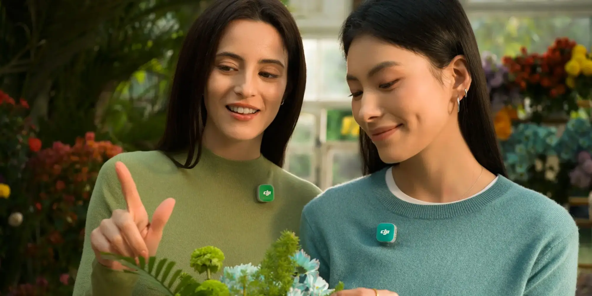 Two women wearing DJI Mic Mini 2 microphones