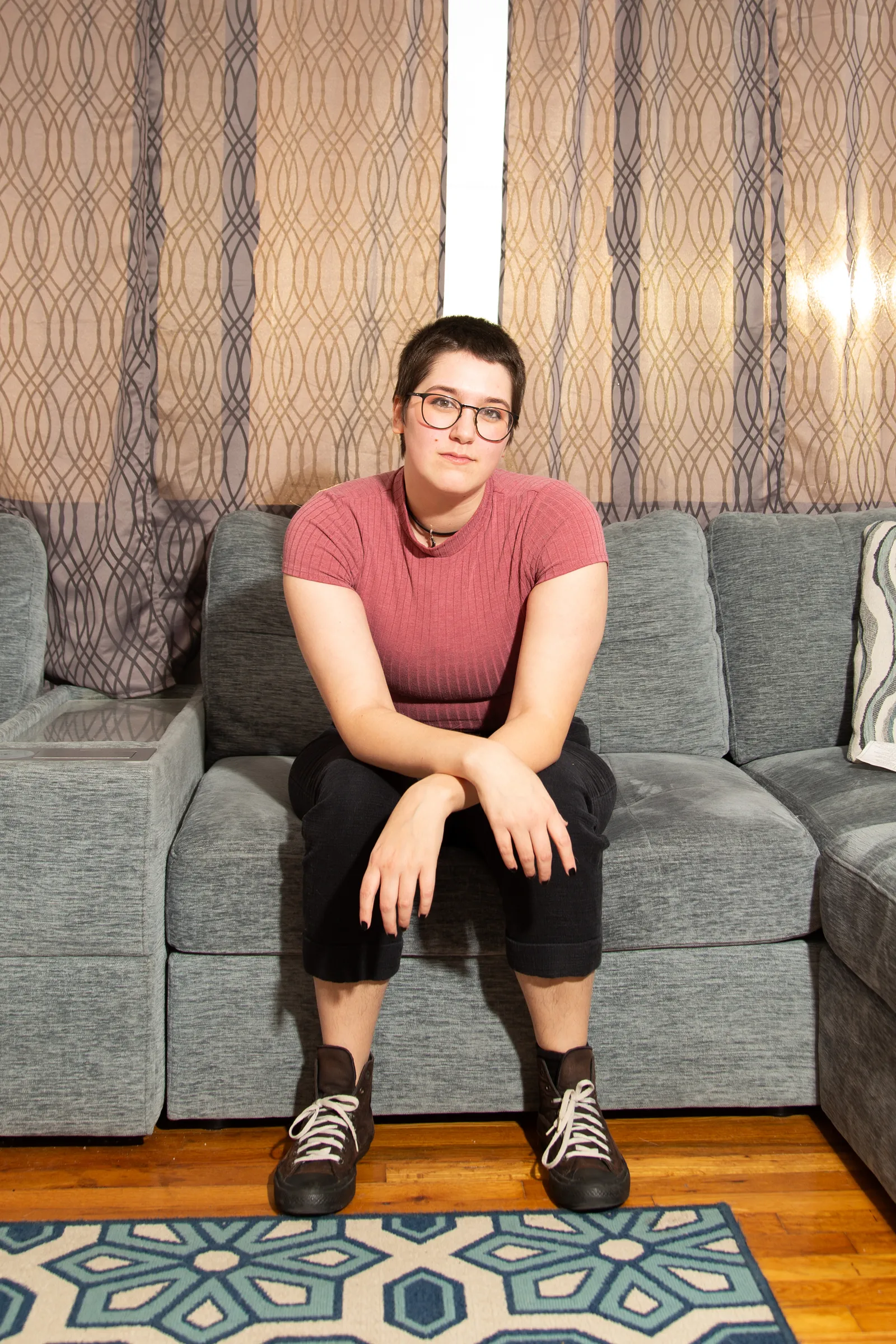 Image may contain Person Sitting Couch Furniture Teen Clothing Shorts Face and Head