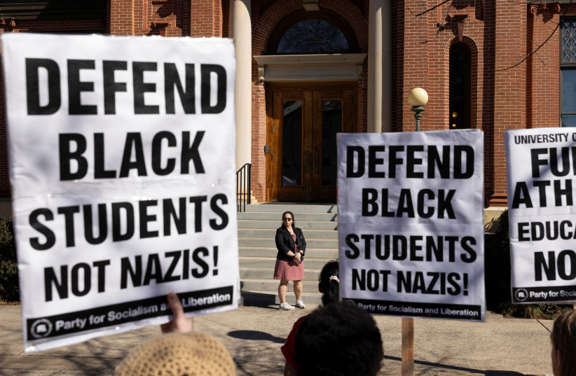 Jan Davis Barham, University of Georgia Associate Vice President for Student Affairs, blocks a group of protestors from entering an administrative building during a rally at the University of Georgia in Athens, Georgia, US, February 4, 2025.