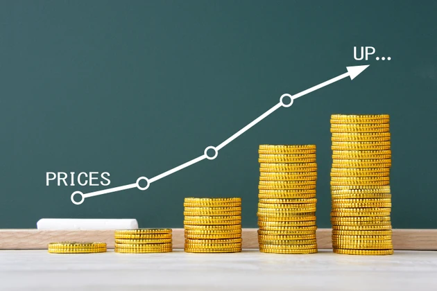 Handwritten graph for price on blackboard and coins