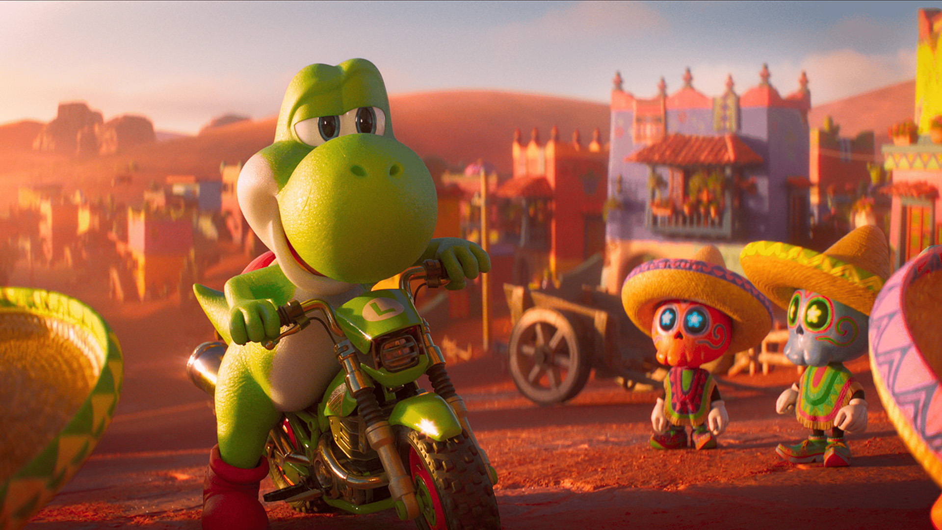 Yoshi rides a green motorcycle with an L on the front, while two small figures wearing sombreros and colorful outfits stand nearby in a vibrant village setting.